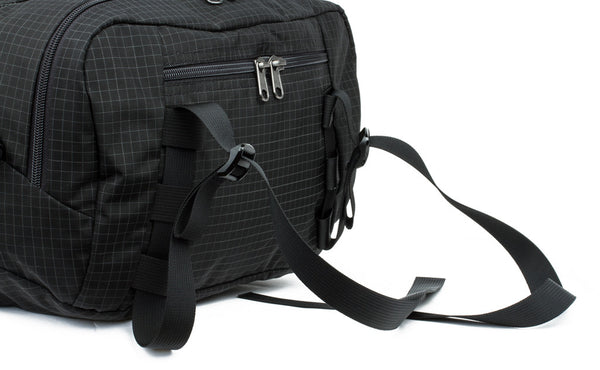 The lash straps at the top of the main pocket of the Hero's Journey in Black (black with grey grid) 400 Halcyon.